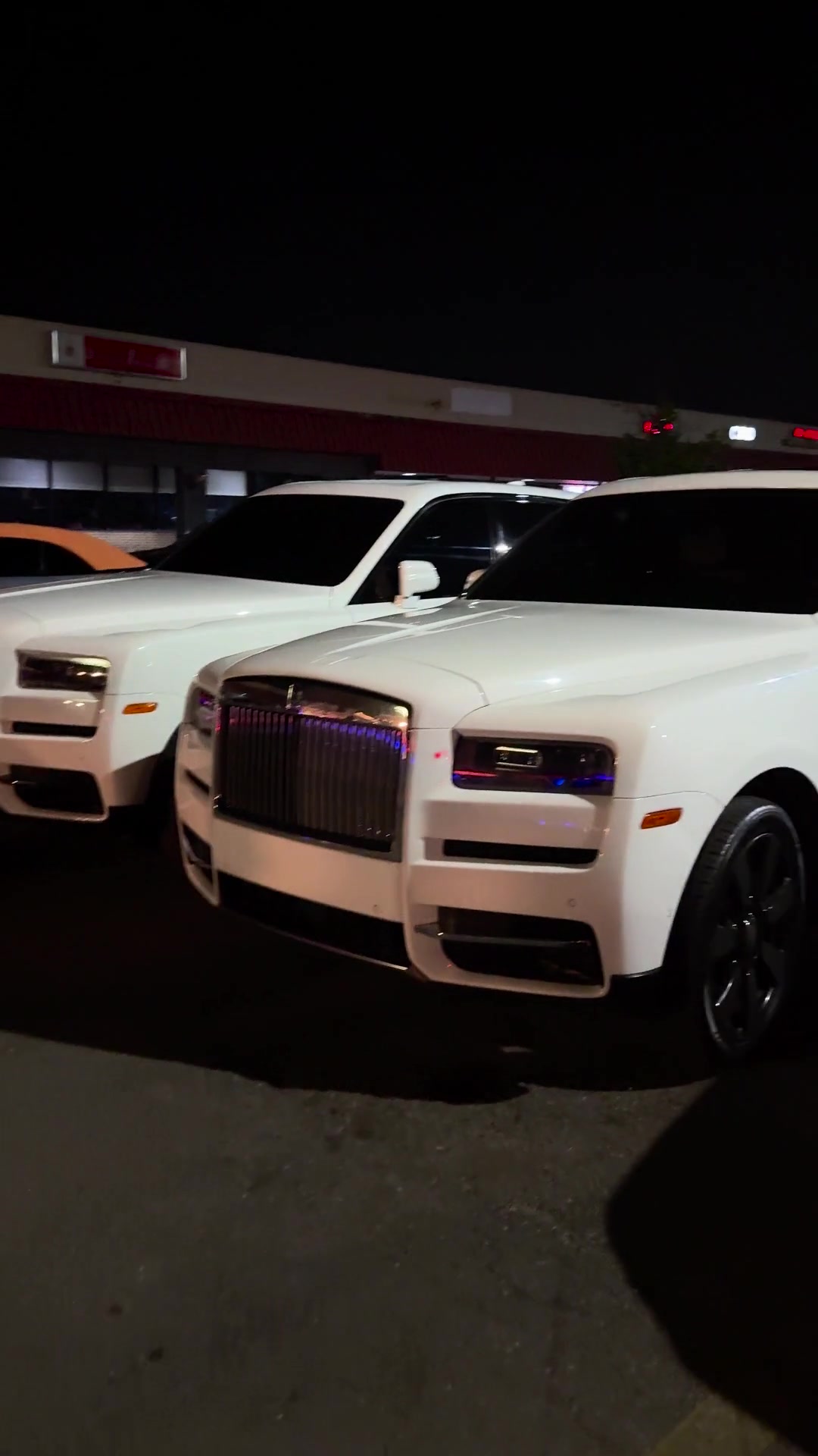 White luxury SUVs outside an event venue